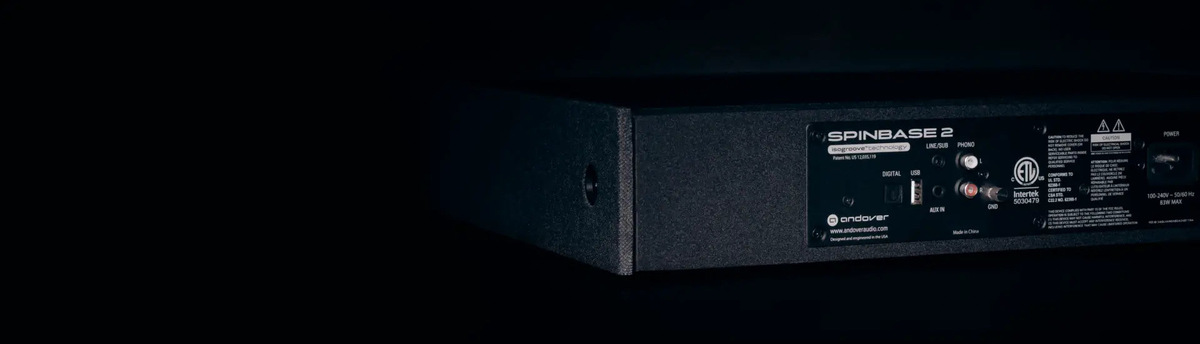 Rear panel of the black SpinBase 2 showing phono, AUX, optical, USB and line/subwoofer connections.