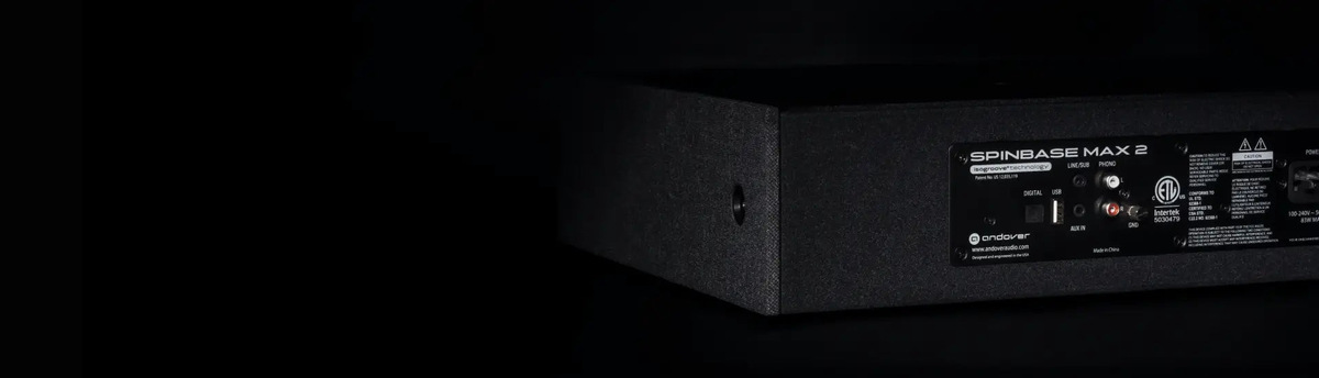 Rear panel of the black SpinBase MAX 2 showing its audio connections and power input.