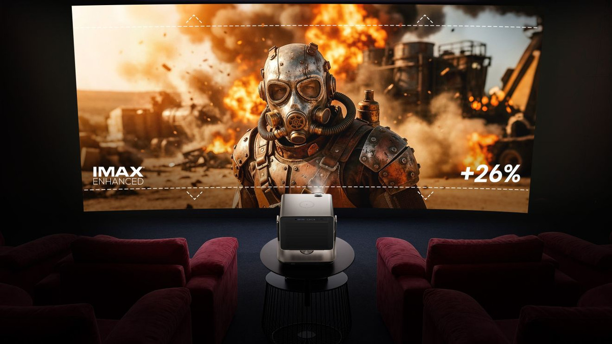 Projected action scene with a figure wearing a gas mask, an IMAX Enhanced logo and a +26% expanded-picture graphic.