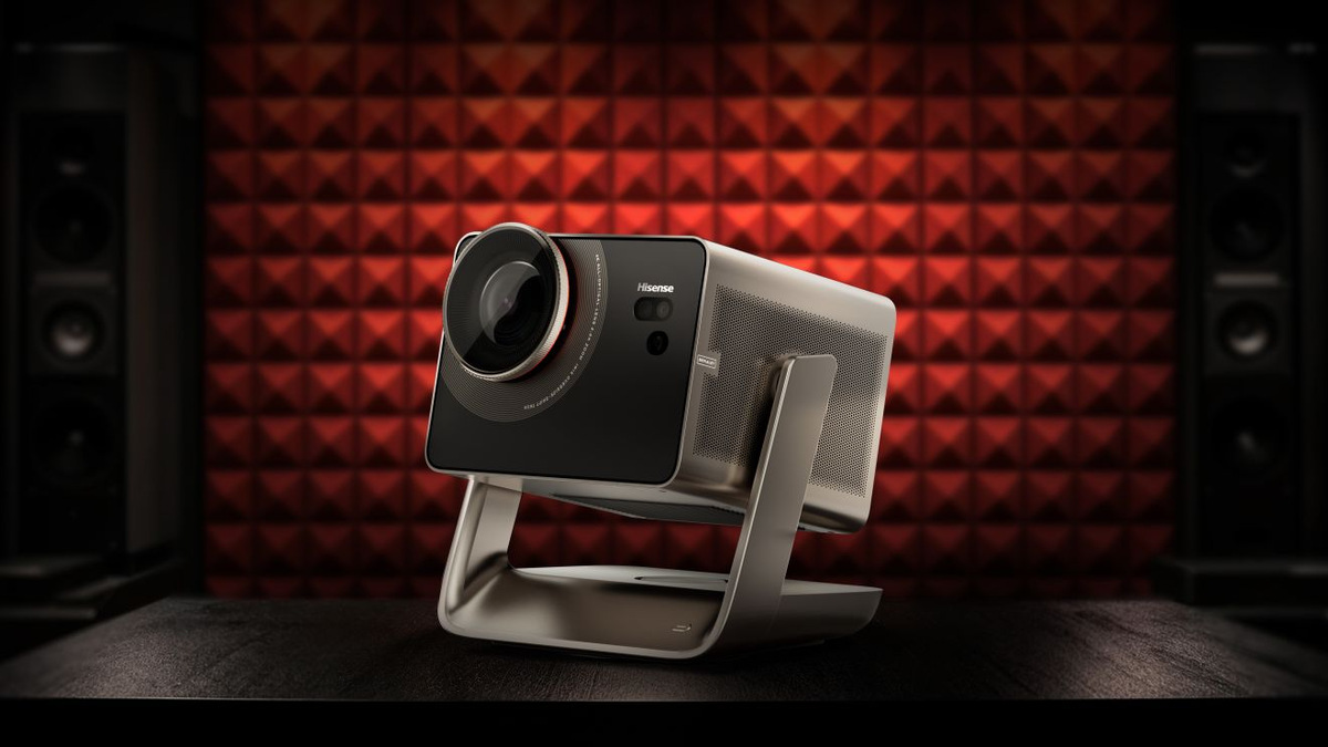 Angled view of the Hisense C3 Ultra Max on its gimbal stand in front of red acoustic panels.