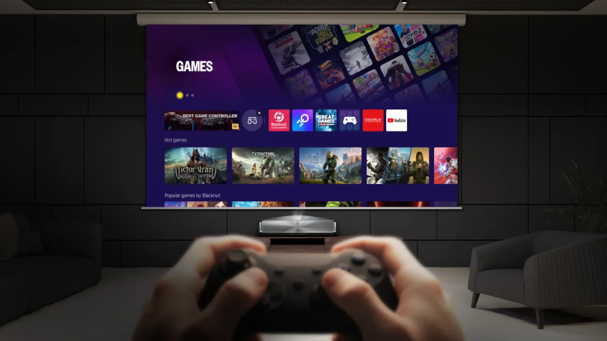Hands holding a games controller in front of a projected VIDAA gaming menu.
